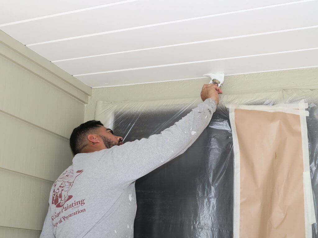 El Gato Painting Team making finishing touches on a house